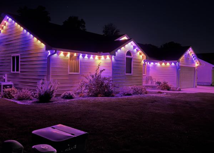 Purple and warm-white lighting along a single-story roofline